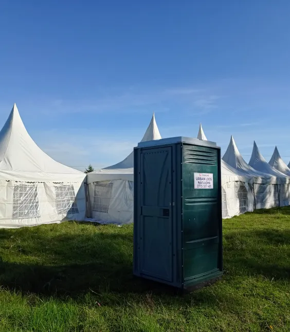Well-maintained UrbanLoos portable toilet at a construction site in Nakuru
